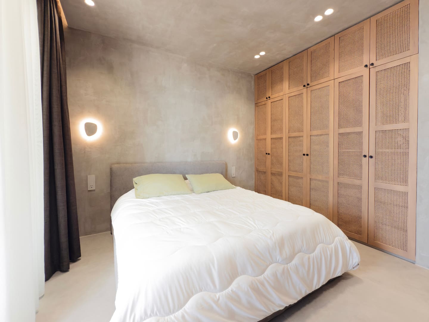 King bedroom at Villa 4 with linen bedding and sliding doors to the terrace.